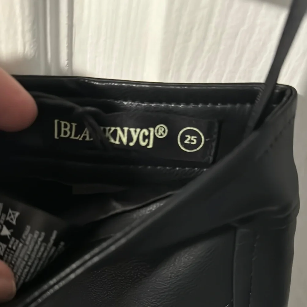 Black Asymmetrical Cut Out Mini Skirt - Picture 2 of 3